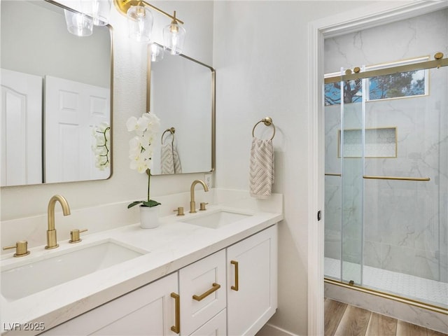 4314 Livorno Ave, Las Vegas, NV 89141 - bathroom with a marble finish shower, double vanity, and wood finished floors