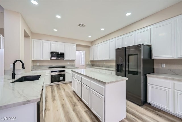 9272 W Viking Rd, Las Vegas, NV 89147 - kitchen featuring stainless steel appliances, white cabinetry, light wood-type flooring, and recessed lighting