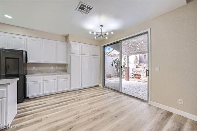 9272 W Viking Rd, Las Vegas, NV 89147 - unfurnished dining area with a chandelier, light wood finished floors, and recessed lighting