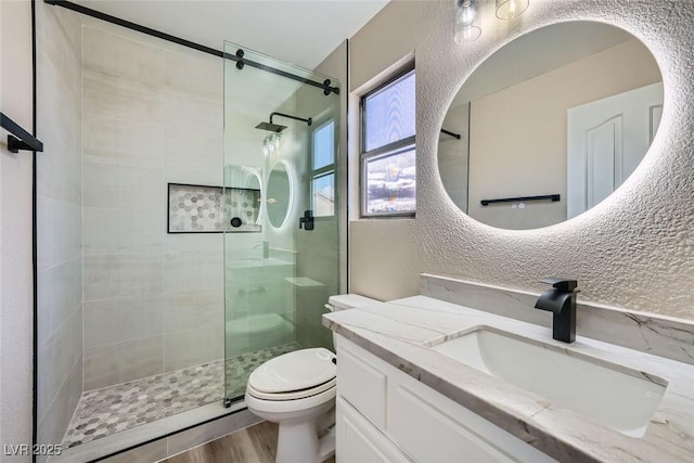 9272 W Viking Rd, Las Vegas, NV 89147 - bathroom featuring vanity, tiled shower, and wood finished floors