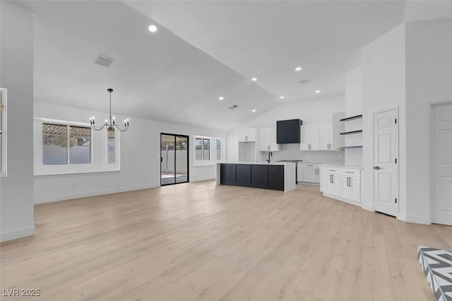 363 El Pico Dr, Henderson, NV 89014 - unfurnished living room featuring a chandelier, light wood-type flooring, high vaulted ceiling, and recessed lighting