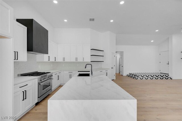 363 El Pico Dr, Henderson, NV 89014 - kitchen with high end range, light wood-type flooring, backsplash, and recessed lighting