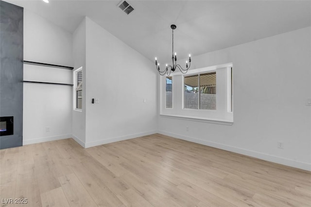 363 El Pico Dr, Henderson, NV 89014 - unfurnished dining area with a chandelier, light wood-type flooring, lofted ceiling, and a fireplace