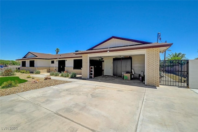 3917 Leon Ave, Las Vegas, NV 89130 - ranch-style house featuring brick siding, concrete driveway, a garage, and a gate