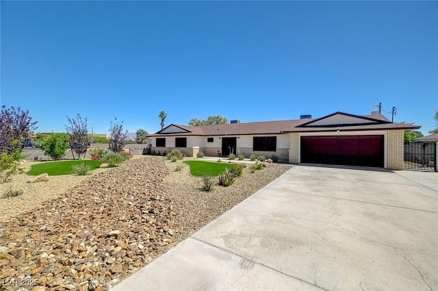 3917 Leon Ave, Las Vegas, NV 89130 - ranch-style home with a garage, driveway, and brick siding
