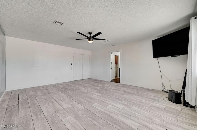 3917 Leon Ave, Las Vegas, NV 89130 - unfurnished living room with ceiling fan, light wood-style floors, and a textured ceiling