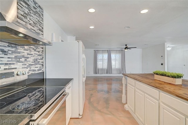 3917 Leon Ave, Las Vegas, NV 89130 - kitchen with stainless steel electric range, exhaust hood, tasteful backsplash, finished concrete flooring, and butcher block countertops