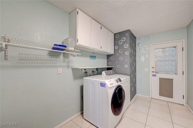 3917 Leon Ave, Las Vegas, NV 89130 - washroom with washer and dryer, light tile patterned floors, cabinet space, and a textured ceiling