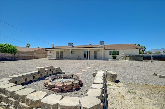 3917 Leon Ave, Las Vegas, NV 89130 - back of property featuring a hot tub, a fire pit, and a patio area