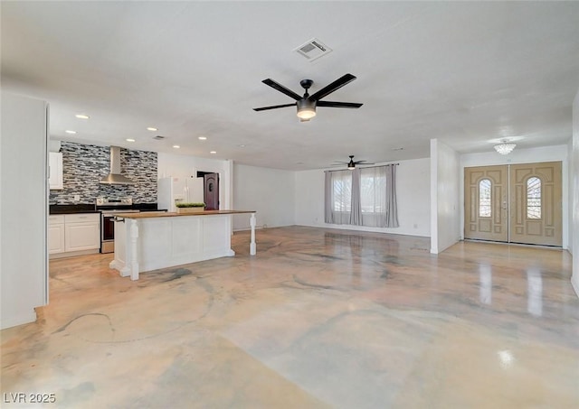 3917 Leon Ave, Las Vegas, NV 89130 - unfurnished living room featuring healthy amount of natural light, concrete floors, ceiling fan, and recessed lighting