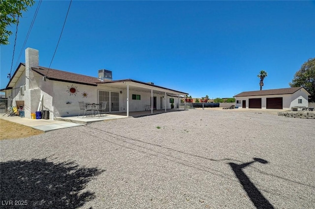 3917 Leon Ave, Las Vegas, NV 89130 - rear view of house with a patio area, stucco siding, and a chimney