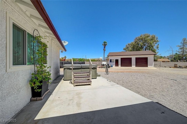 3917 Leon Ave, Las Vegas, NV 89130 - view of patio featuring a hot tub, a garage, and an outdoor structure