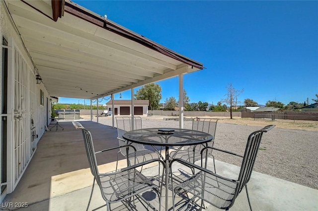 3917 Leon Ave, Las Vegas, NV 89130 - view of patio featuring outdoor dining space and an outbuilding