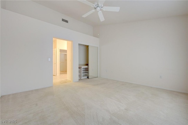 2808 Crown Ridge Dr, Las Vegas, NV 89134 - unfurnished bedroom featuring light carpet, a closet, lofted ceiling, and a ceiling fan
