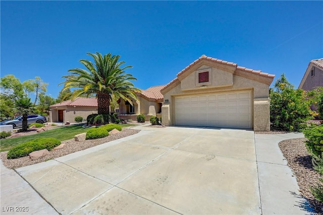 2808 Crown Ridge Dr, Las Vegas, NV 89134 - mediterranean / spanish house featuring a tiled roof, stucco siding, concrete driveway, and an attached garage