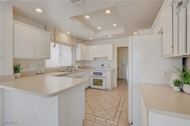 2808 Crown Ridge Dr, Las Vegas, NV 89134 - kitchen with white appliances, light tile patterned flooring, recessed lighting, under cabinet range hood, and a peninsula