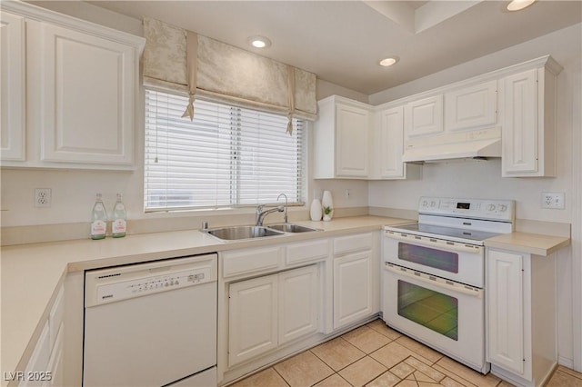 2808 Crown Ridge Dr, Las Vegas, NV 89134 - kitchen with white appliances, under cabinet range hood, white cabinetry, light tile patterned floors, and recessed lighting