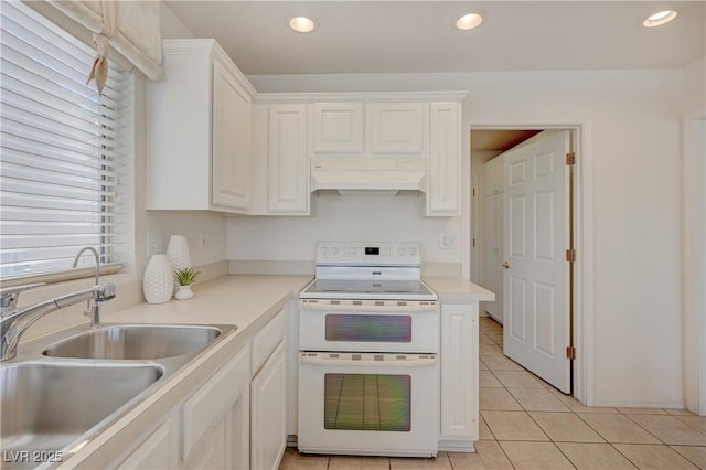 2808 Crown Ridge Dr, Las Vegas, NV 89134 - kitchen featuring range with two ovens, custom range hood, white cabinets, light tile patterned flooring, and light countertops