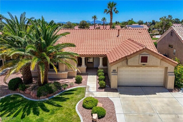 2808 Crown Ridge Dr, Las Vegas, NV 89134 - mediterranean / spanish-style house featuring a tile roof, a garage, driveway, and stucco siding