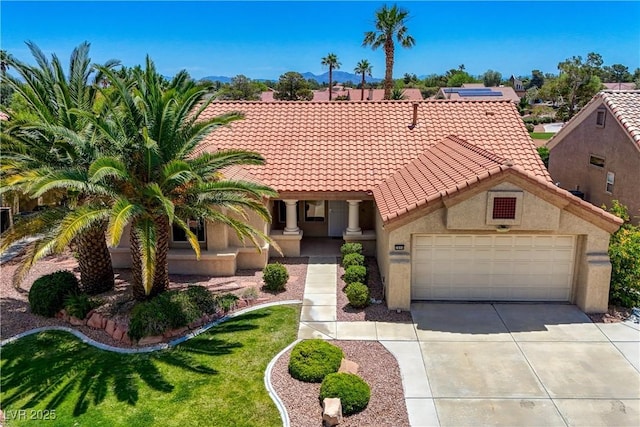 2808 Crown Ridge Dr, Las Vegas, NV 89134 - mediterranean / spanish-style house featuring a tiled roof, a garage, driveway, and stucco siding