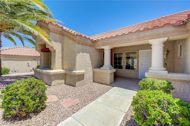 2808 Crown Ridge Dr, Las Vegas, NV 89134 - view of exterior entry featuring a tiled roof and stucco siding