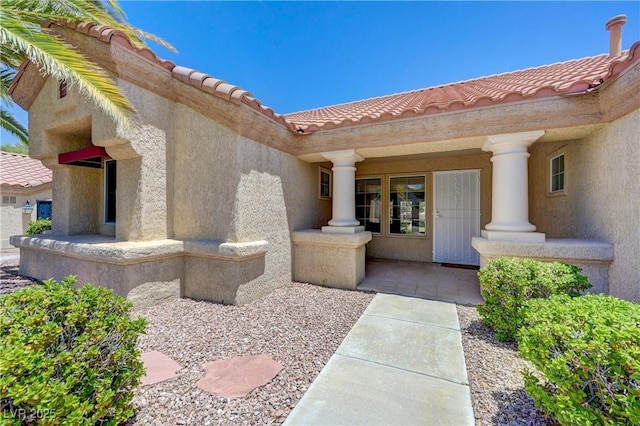 2808 Crown Ridge Dr, Las Vegas, NV 89134 - entrance to property featuring a tile roof and stucco siding