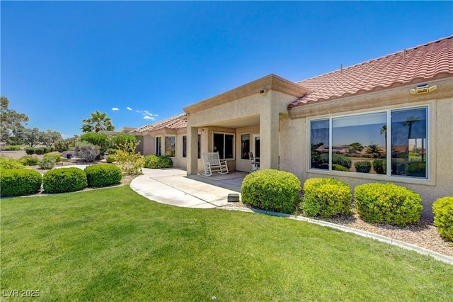 2808 Crown Ridge Dr, Las Vegas, NV 89134 - rear view of house featuring stucco siding, a yard, a tiled roof, and a patio