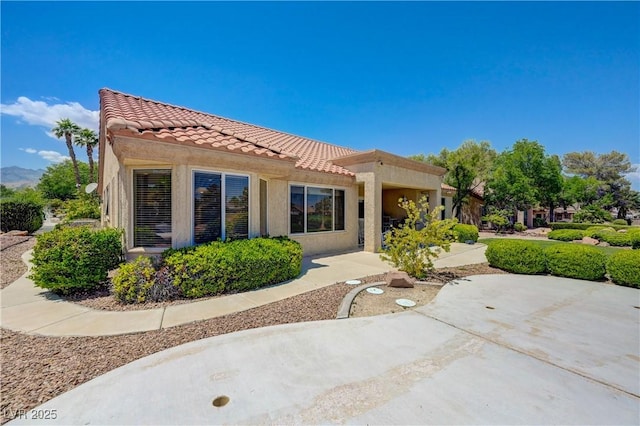 2808 Crown Ridge Dr, Las Vegas, NV 89134 - back of property with a tiled roof, stucco siding, and a patio
