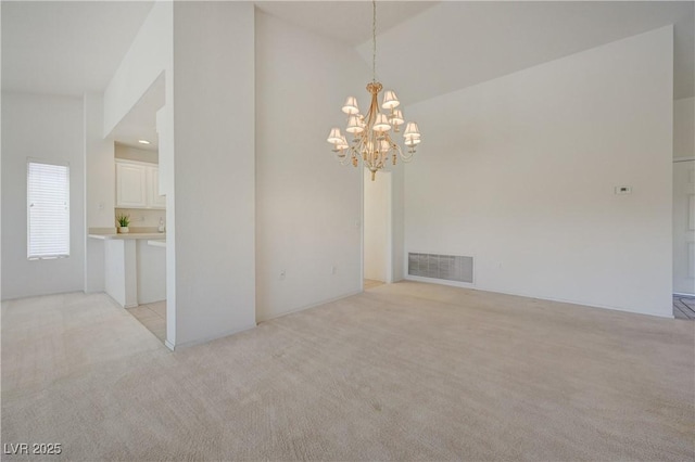 2808 Crown Ridge Dr, Las Vegas, NV 89134 - empty room featuring light carpet, a chandelier, and lofted ceiling