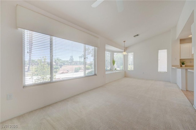 2808 Crown Ridge Dr, Las Vegas, NV 89134 - spare room featuring light carpet, vaulted ceiling, and ceiling fan