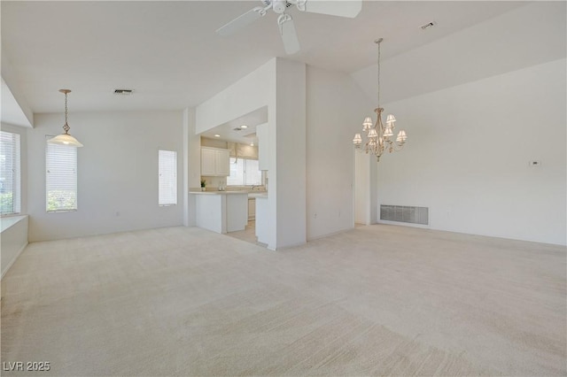 2808 Crown Ridge Dr, Las Vegas, NV 89134 - unfurnished living room featuring light colored carpet, a chandelier, ceiling fan, and lofted ceiling