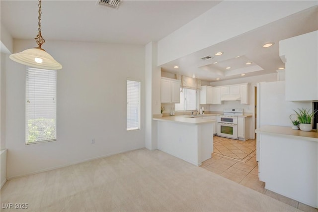 2808 Crown Ridge Dr, Las Vegas, NV 89134 - kitchen featuring white appliances, a peninsula, light carpet, recessed lighting, and light countertops