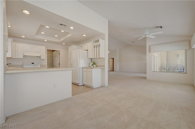 2808 Crown Ridge Dr, Las Vegas, NV 89134 - kitchen with freestanding refrigerator, stove, light carpet, open floor plan, and recessed lighting