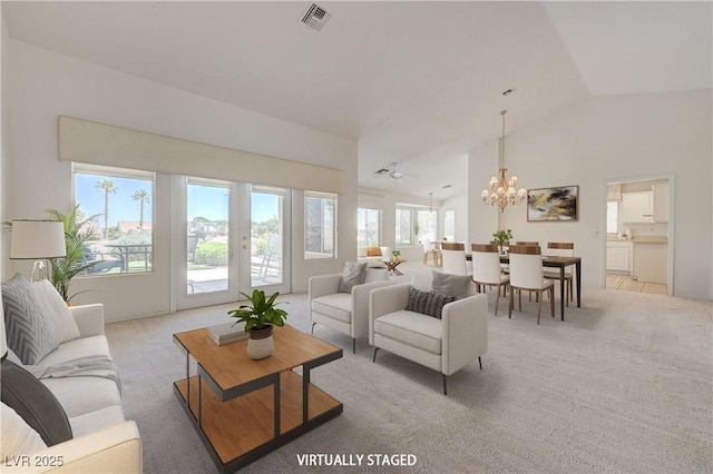2808 Crown Ridge Dr, Las Vegas, NV 89134 - living room featuring vaulted ceiling, a chandelier, and light colored carpet