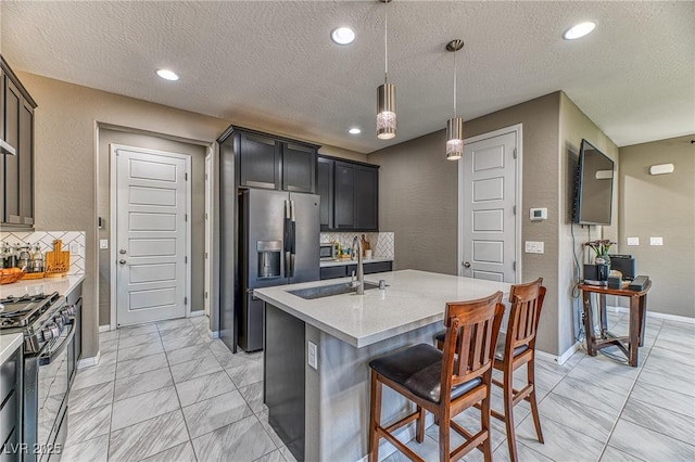 10042 Bismuth St, Las Vegas, NV 89183 - kitchen with stainless steel fridge with ice dispenser, gas range oven, light countertops, tasteful backsplash, and a kitchen bar