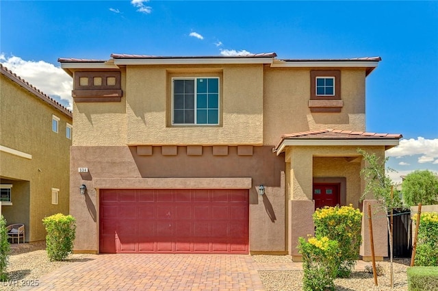 934 Twincrest Ave, North Las Vegas, NV 89032 - view of front of home featuring a garage, stucco siding, decorative driveway, and a tile roof