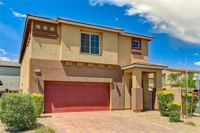 934 Twincrest Ave, North Las Vegas, NV 89032 - view of front of house with an attached garage, decorative driveway, and stucco siding