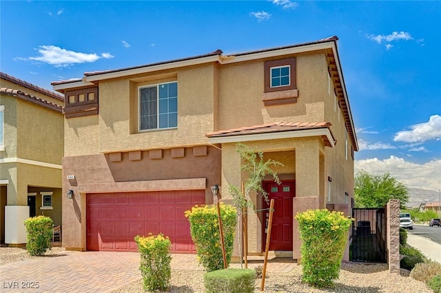 934 Twincrest Ave, North Las Vegas, NV 89032 - view of front of home featuring an attached garage, stucco siding, decorative driveway, and a tile roof