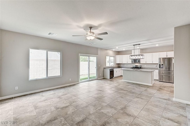 934 Twincrest Ave, North Las Vegas, NV 89032 - kitchen featuring stainless steel appliances, open floor plan, white cabinets, a ceiling fan, and recessed lighting
