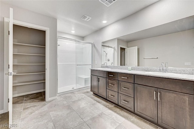 934 Twincrest Ave, North Las Vegas, NV 89032 - full bathroom with double vanity, a shower stall, a spacious closet, and recessed lighting