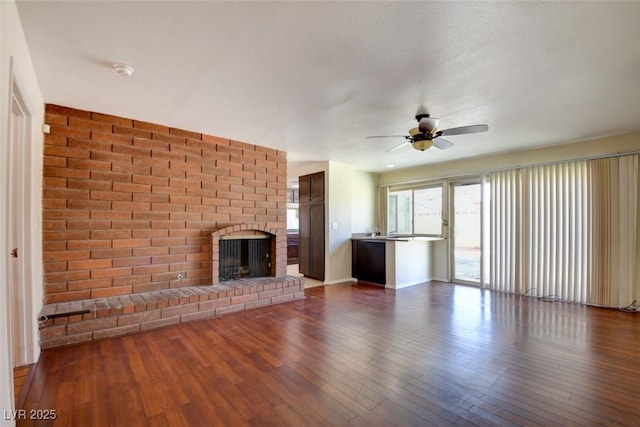 6822 Garden Grove Ave, Las Vegas, NV 89103 - unfurnished living room featuring ceiling fan, dark wood-style flooring, and a brick fireplace