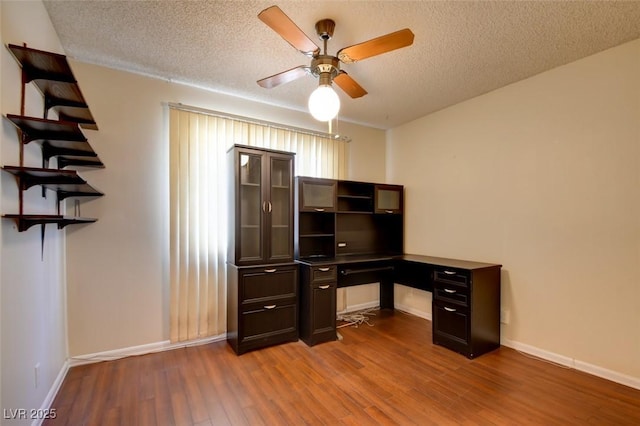 6822 Garden Grove Ave, Las Vegas, NV 89103 - office space featuring a ceiling fan, wood finished floors, a textured ceiling, and built in desk