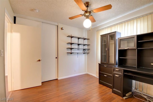 6822 Garden Grove Ave, Las Vegas, NV 89103 - unfurnished office with wood finished floors, ceiling fan, and a textured ceiling