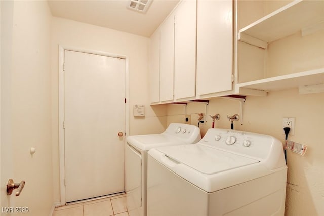 6822 Garden Grove Ave, Las Vegas, NV 89103 - laundry room featuring washer and clothes dryer, cabinet space, and light tile patterned floors