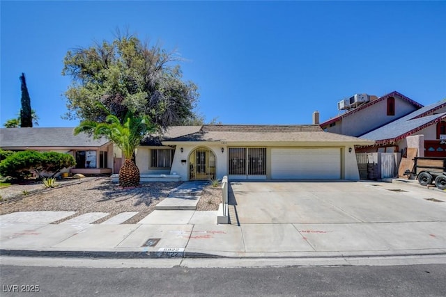 6822 Garden Grove Ave, Las Vegas, NV 89103 - ranch-style home featuring a garage, concrete driveway, and stucco siding