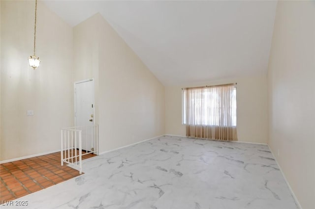 6822 Garden Grove Ave, Las Vegas, NV 89103 - unfurnished room with lofted ceiling and marble finish flooring