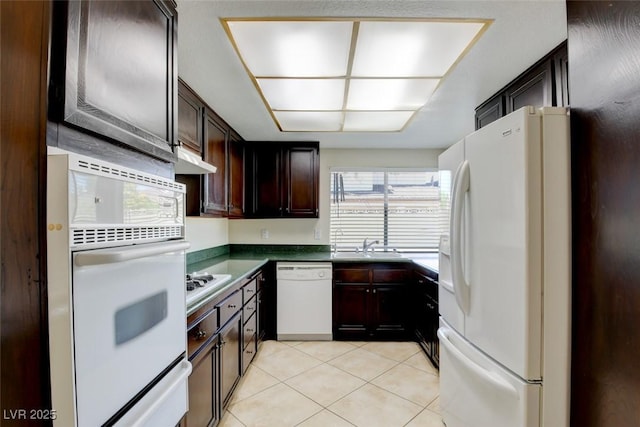 6822 Garden Grove Ave, Las Vegas, NV 89103 - kitchen featuring white appliances, light tile patterned floors, dark brown cabinetry, a warming drawer, and under cabinet range hood