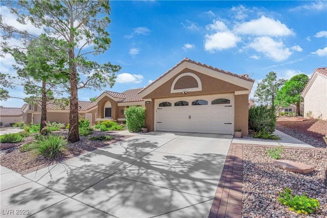 9237 Quail Ridge Dr, Las Vegas, NV 89134 - view of front of property featuring stucco siding, concrete driveway, a tiled roof, and a garage