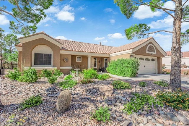 9237 Quail Ridge Dr, Las Vegas, NV 89134 - view of front of property with stucco siding, an attached garage, a tiled roof, and driveway