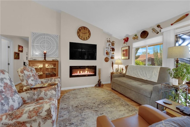 9237 Quail Ridge Dr, Las Vegas, NV 89134 - living room with a glass covered fireplace, wood finished floors, and high vaulted ceiling